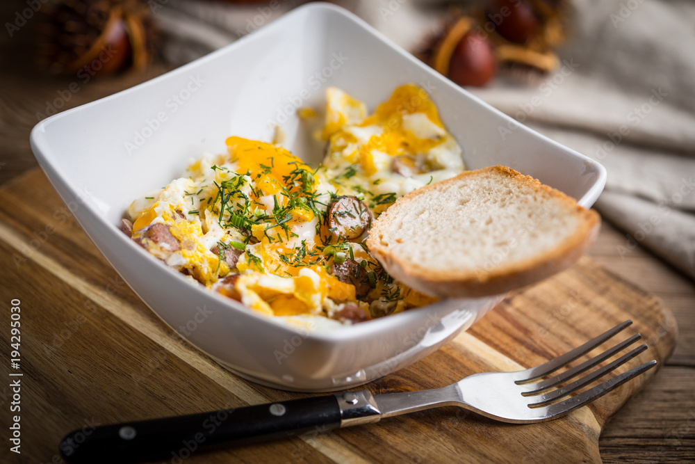 Scrambled eggs with sausage and bread. Scrambled eggs with sausage and bread.