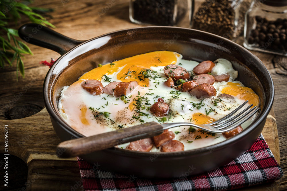 Tasty cooked egg with chopped sausages. Tasty cooked egg with chopped sausages.