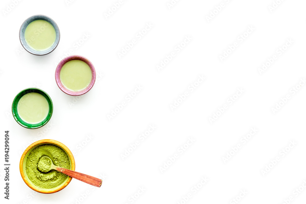 Brew matcha tea. Bowl with powder and cups with beverage on white background top view copy space Brew matcha tea. Bowl with powder and cups with beverage on white background top view copy space