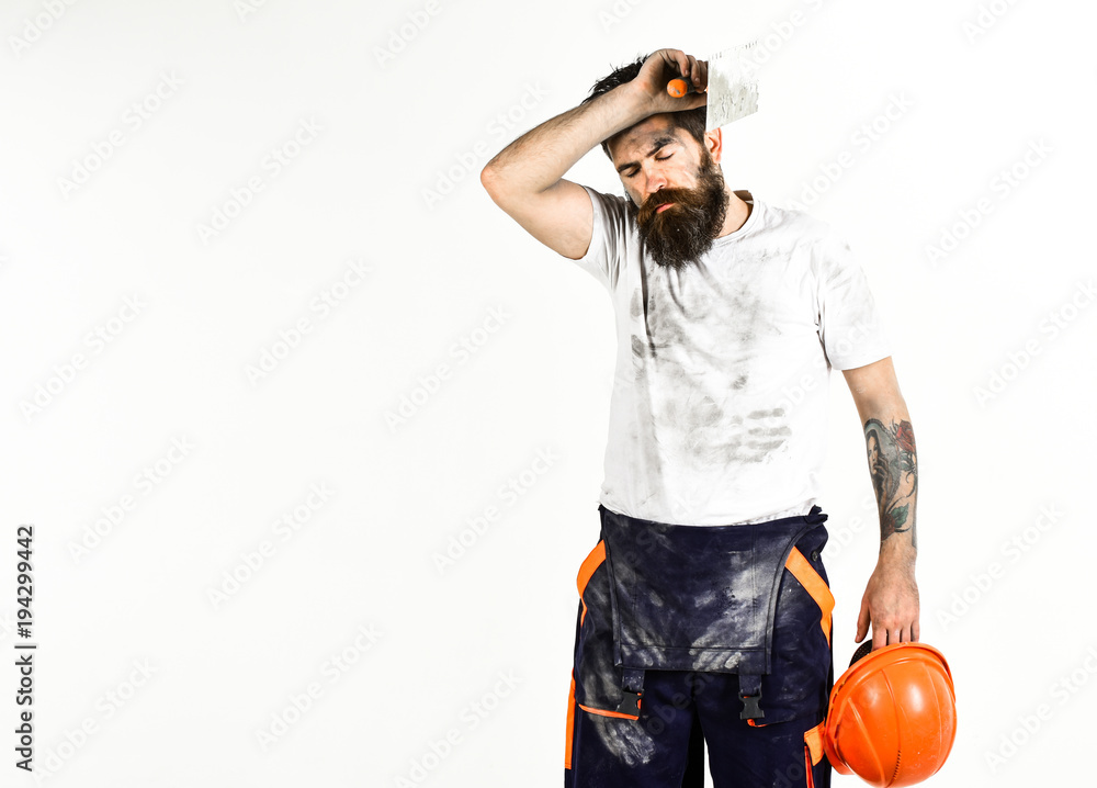 Builder, plasterer, repairman, foreman holds putty knife, plastering tool