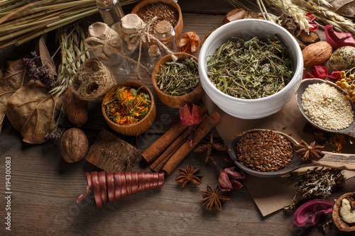 Fototapeta Naklejka Na Ścianę i Meble -  Bunch of healing herbs on wooden board. Herbal medicine. Top view.