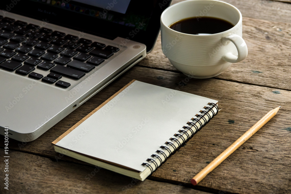 Top view of blank notebook with white coffee, laptop and with natural light on wooden table. Top view of blank notebook with white coffee, laptop and with natural light on wooden table.