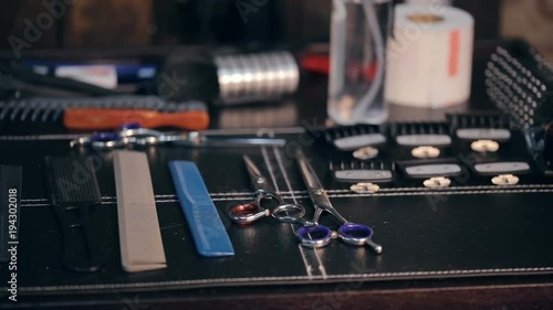 Close-up panorama shot of hairdresser tools. Scissors and combs.