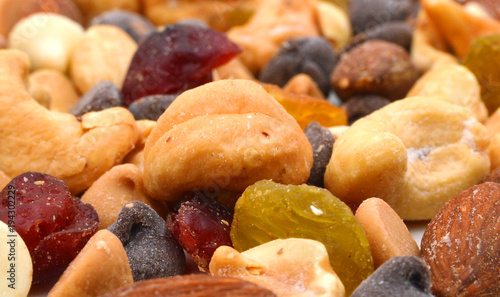 Close up of a mixed of nuts, dry fruits and chocolate
