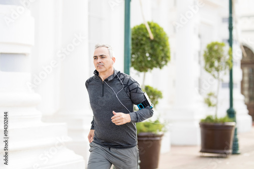 Middle aged man running in the city