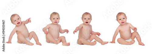 Four equal babies sitting on the floor