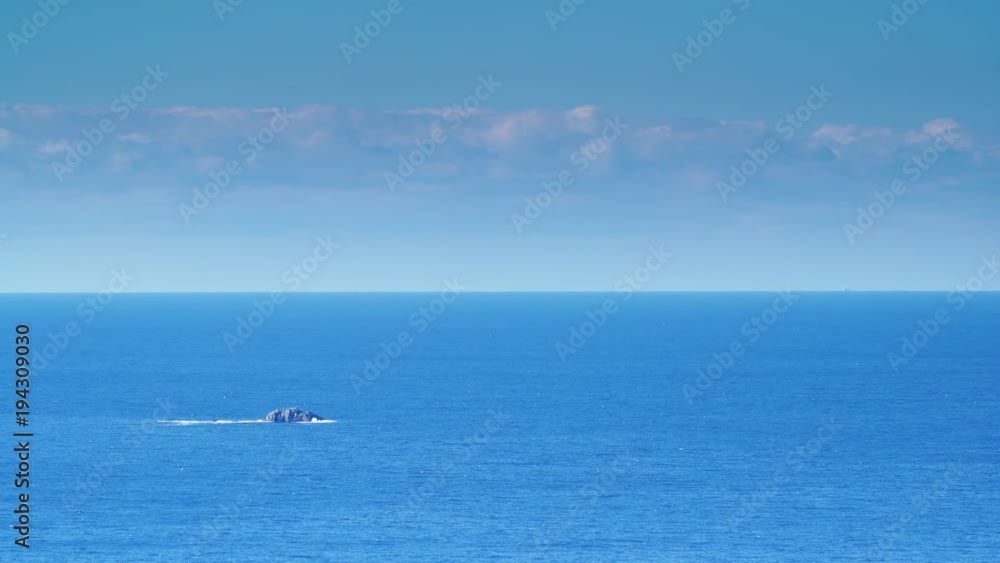 Greek blue calm sea water surface with little rocky island and skyline, Greece Peloponnese Mani Peninsula. Greek blue calm sea water surface with little rocky island and skyline, Greece Peloponnese Mani Peninsula.