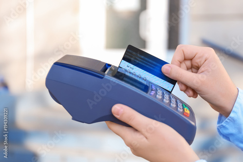 Woman using bank terminal f...