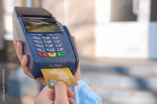 Woman using bank terminal f...