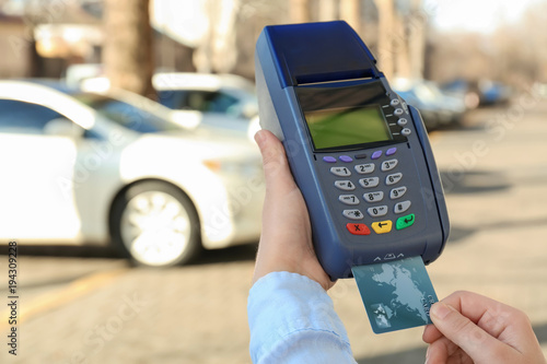 Woman using bank terminal f...