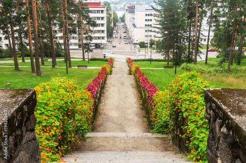 Vászonkép Stone stairs with flowers in city park