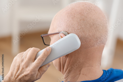 Senior man with hearing aid...