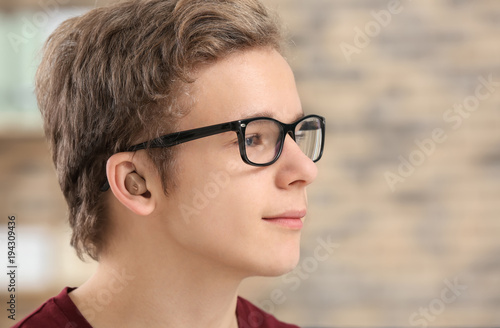 Teenage boy with hearing ai...