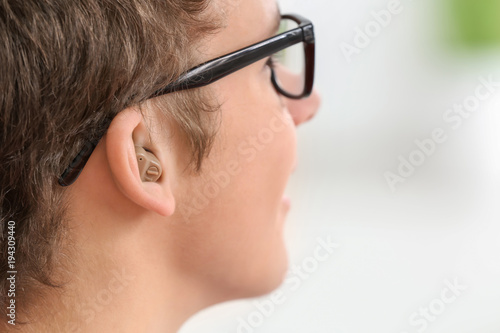 Teenage boy with hearing ai...