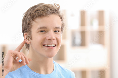 Teenage boy with hearing ai...