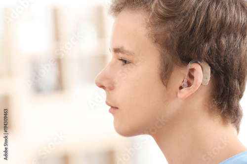 Teenage boy with hearing ai...