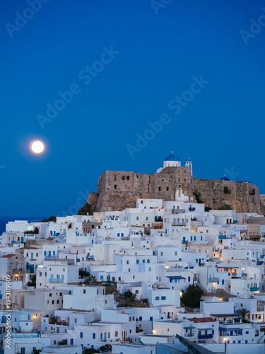 Chora of Astypalaia in blue hour and the full moon rising behind the fortress © George