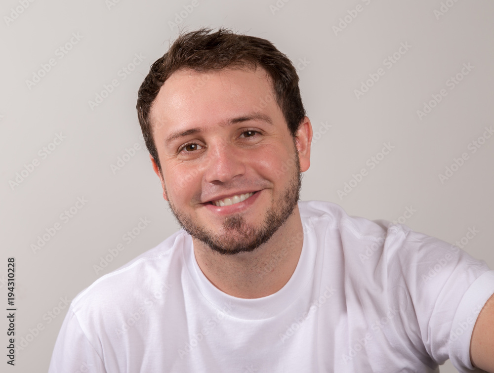 Young man in white shirt smiling Young man in white shirt smiling