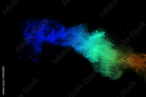 Abstract multicolored dust explosion on black background. Abstract color powder splattered on dark background.