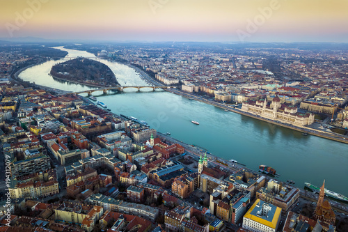 Budapest, Hungary - Aerial skyline view of Budapest with Parliament of Hungary, Margaret Island and Bridge and sightseeing boat on River Danube at sunset photo