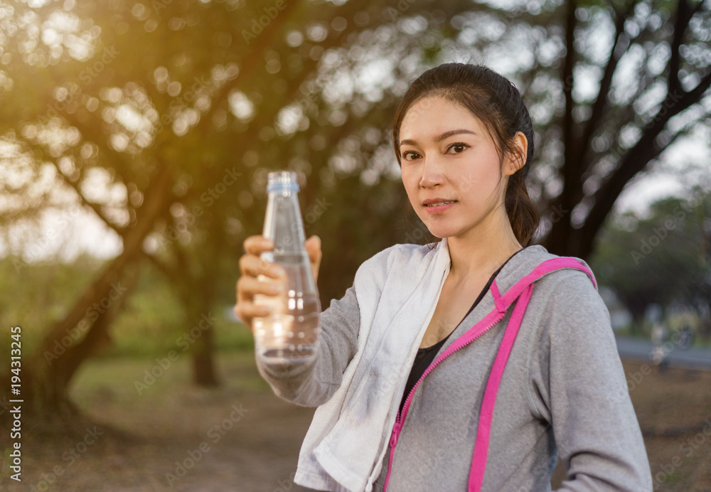 young sporty woman with bottle of water in park young sporty woman with bottle of water in park