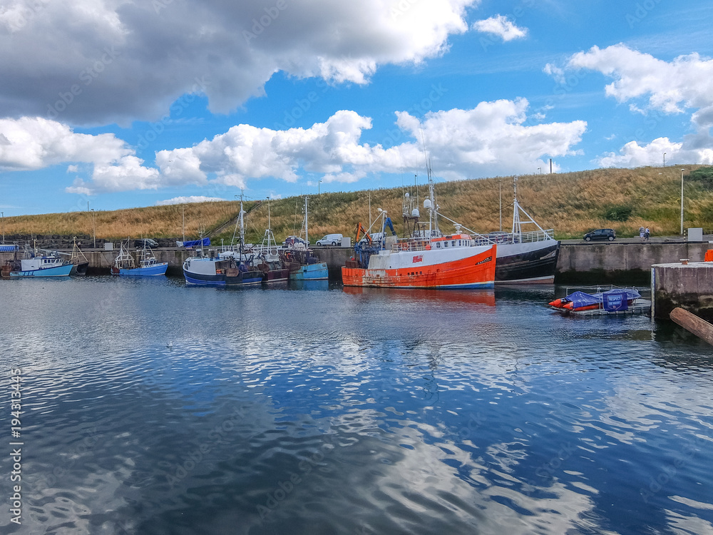 Scottish fishing boats are resting in the harbor after hard early morning job 