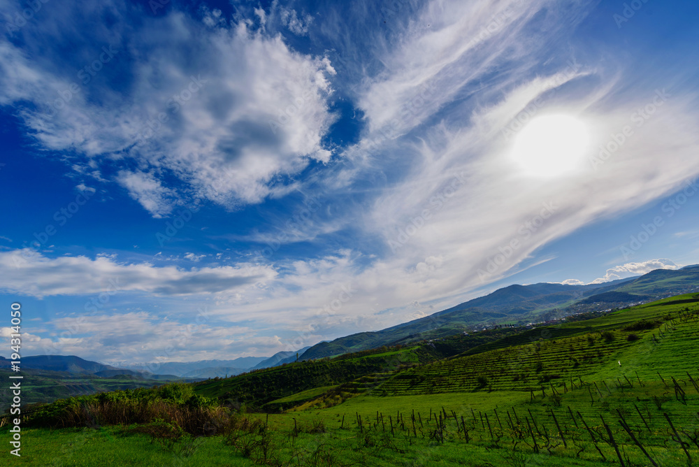 Amazing spring skyscape with beautiful clouds and green field, Armenia