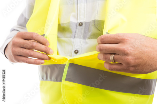 Foto Constructor hands closing velcro reflective protective vest.