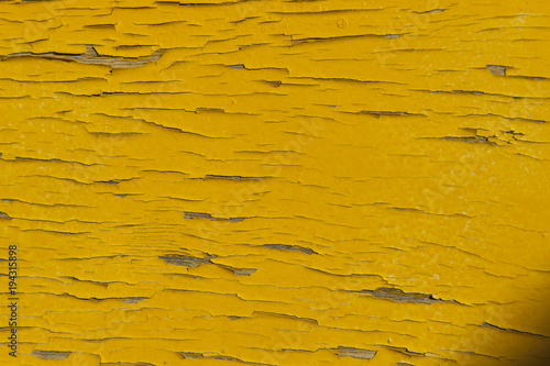 Yellow painted broken wood texture. Close up. Copy space