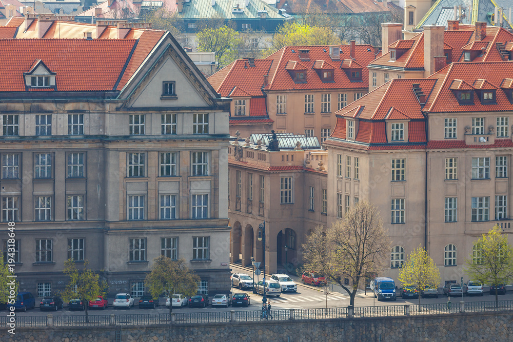 Prague rooftops and embankment. Beautiful aerial view of old buildings along Vltava river.