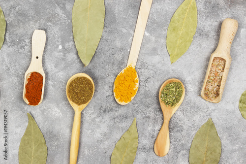 Various spices on a gray background. Top view. Food background