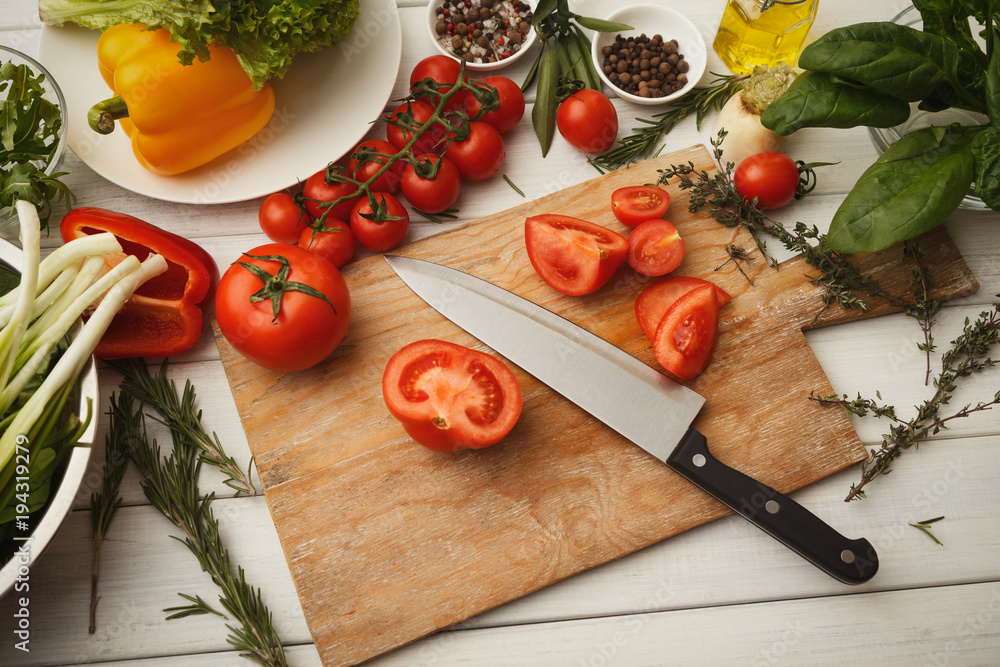 Preparing fresh vegetable salad at kitchen table Preparing fresh vegetable salad at kitchen table