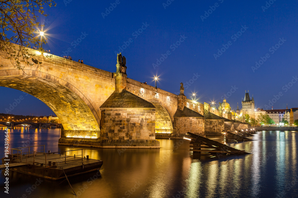 Scenic summer night view of the Charles bridge over Vltava river in Prague, Czech Republic. Illuminated beauty.