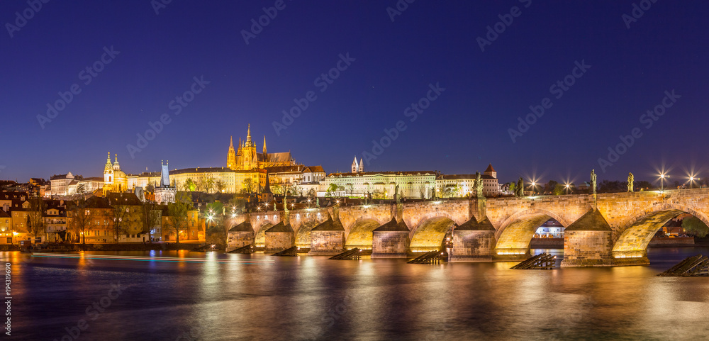 Amazing night panoramic view of Hradcany (Prague Castle) with St. Vitus Cathedral and Charles bridge at night, Bohemia landmark. Prague, Czech Republic.