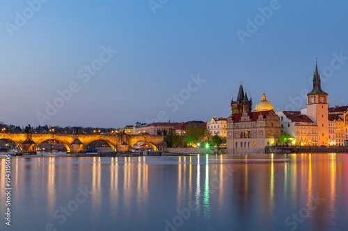 Scenic summer evening view of the Old Town ancient architecture and the Charles bridge over Vltava river in Prague, Czech Republic