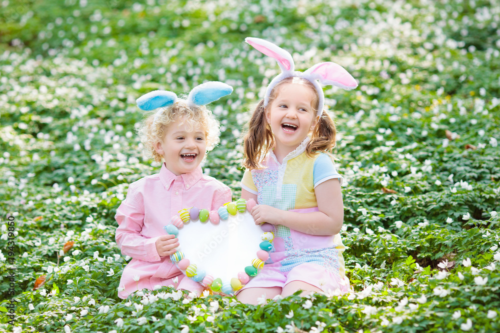 Kids with bunny ears on Easter egg hunt. Kids with bunny ears on Easter egg hunt.