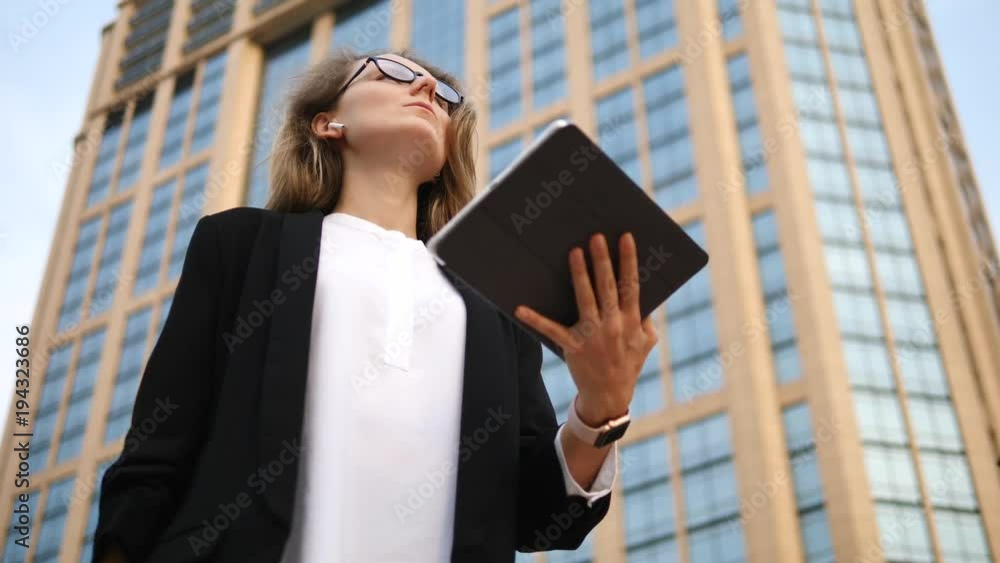 Business Woman Using Tablet In AirPods In City Business Woman Using Tablet In AirPods In City