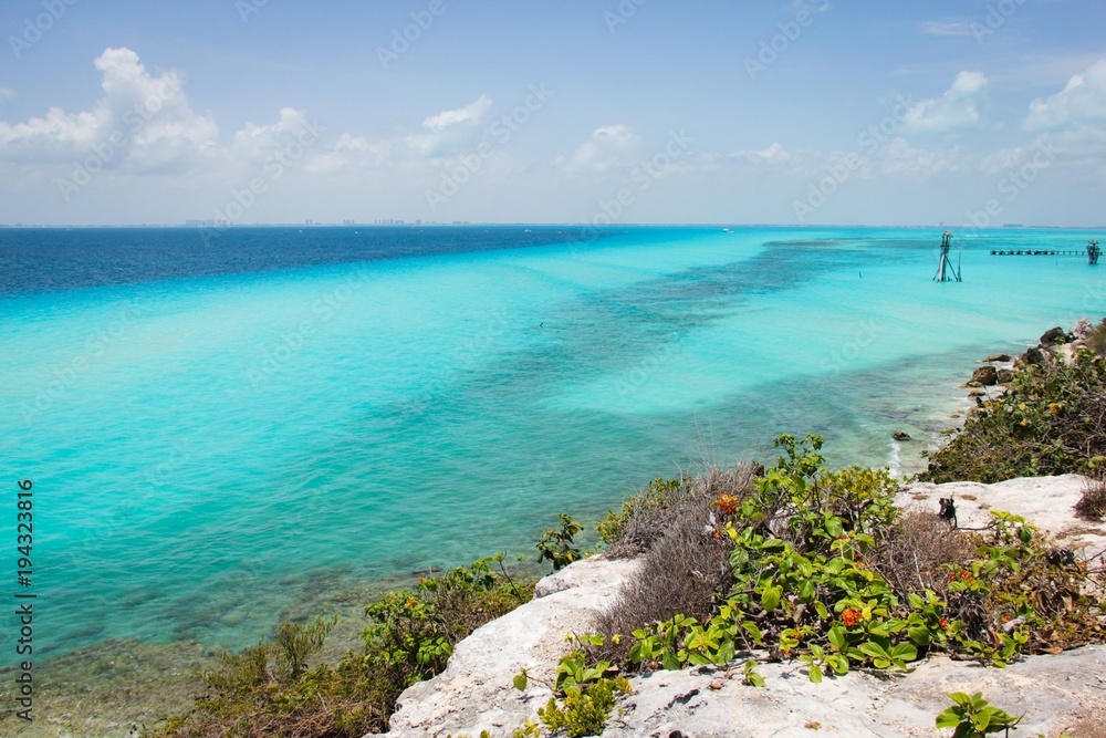 Magnificent views of Caribbean Sea of turquoise and blue water from Isla Mujeres island, Mexico. Exotic paradise, travel vacation destination concept Magnificent views of Caribbean Sea of turquoise and blue water from Isla Mujeres island, Mexico. Exotic paradise, travel vacation destination concept