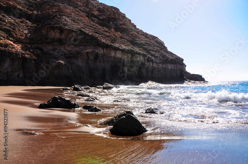 Calm scenery of natural and unspoiled beach Tiritaña. Bay framed by high cliffs in barranco near Taurito/Mogan. Between Punta de la Cruz de Piedra and Punta de los Medios Almudes. Gran Canaria