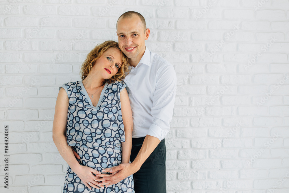 Young happy pregnant couple in love. Laughing and smiling man and woman. Happy pregnancy concept Young happy pregnant couple in love. Laughing and smiling man and woman. Happy pregnancy concept
