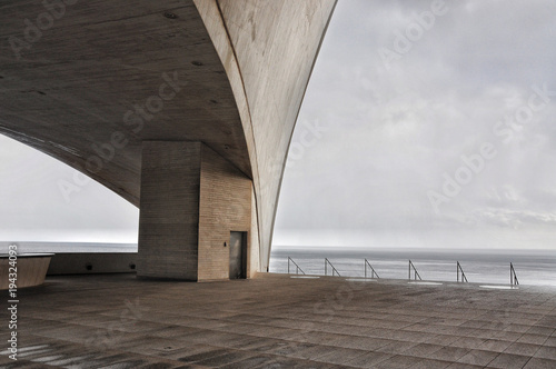 Concrete terrace with misterious industrial Atlantic Ocean view in Santa Cruz of Tenerife. Minimalistic architecture. Cold colors