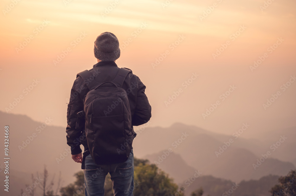 Man alone in forest mountains on background outdoor with sunset, Lifestyle Travel concept, Rear view, copy space