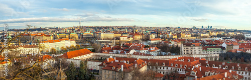 View of Prague over houses with red roofs. Amazing view from above at old historical quarter. Prague, Czech Republic. Prague is famous and popular travel destination city
