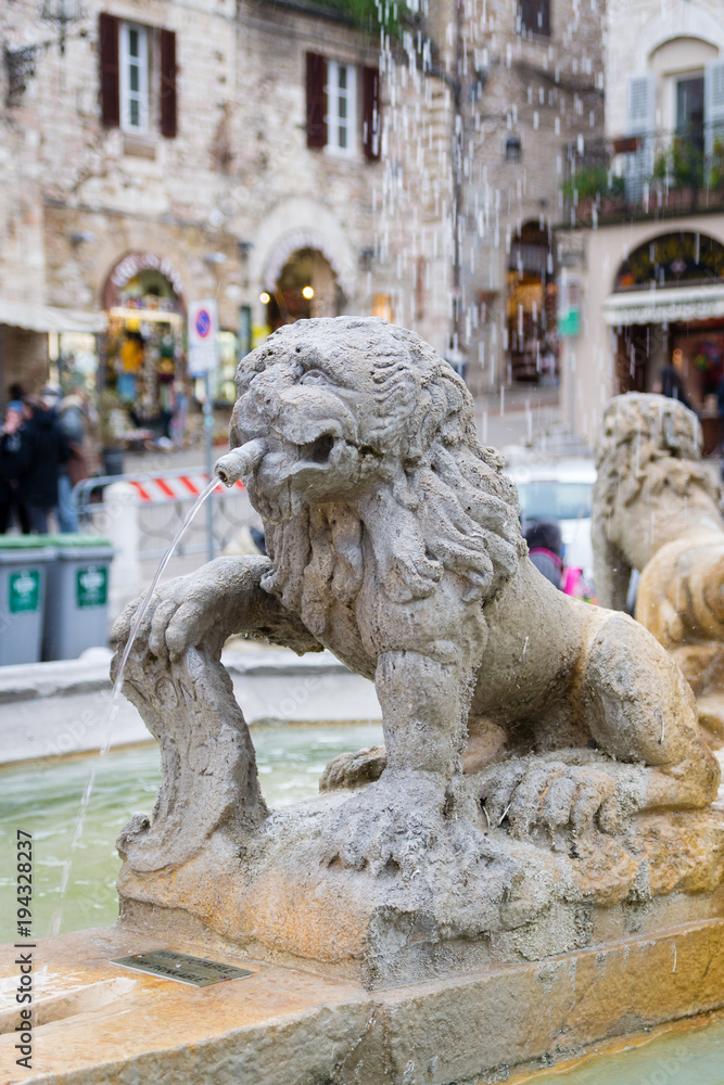 Lion fountain in the square of Assisi, Umbria, Italy