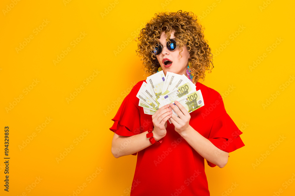 Attractive woman with short curly hair with cash