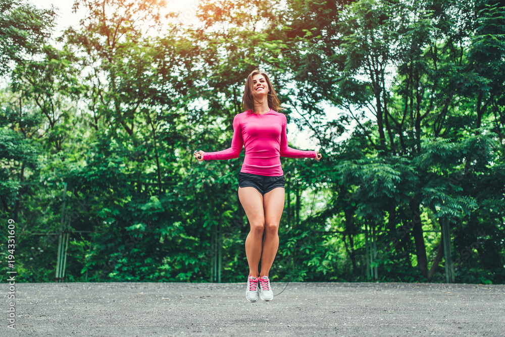 Cute sporty girl with rope training outdoor Cute sporty girl with rope training outdoor