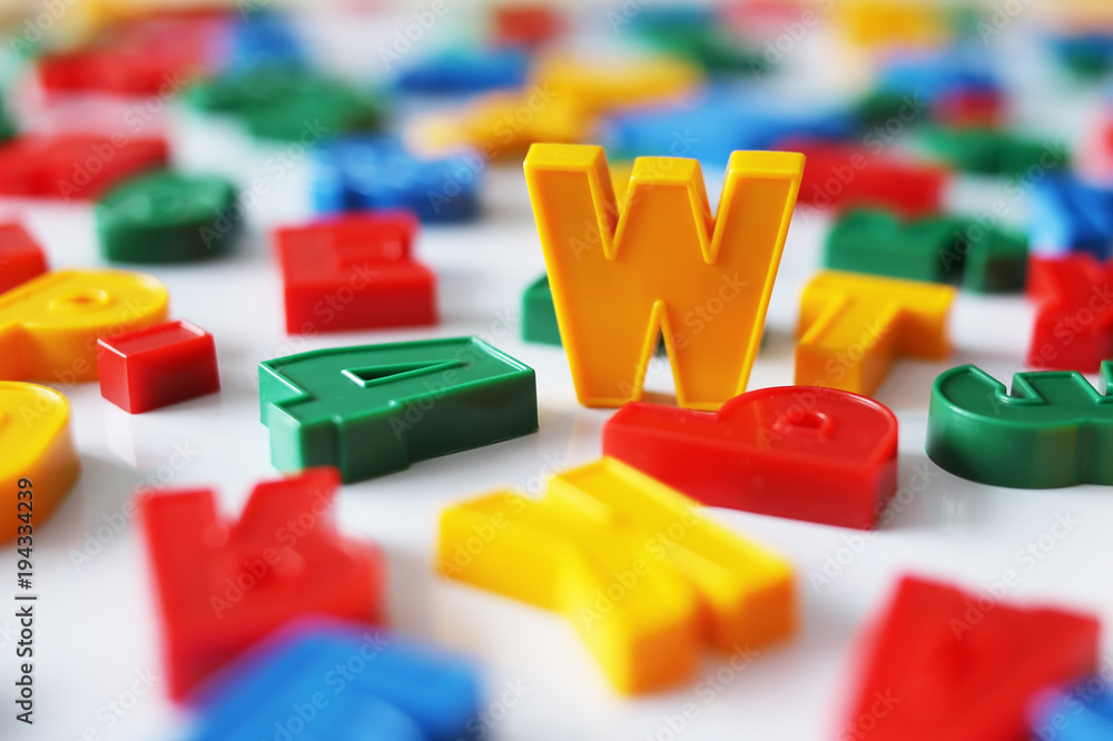 Letter W among the letters of the colorful alphabet on the magnet Letter W among the letters of the colorful alphabet on the magnet