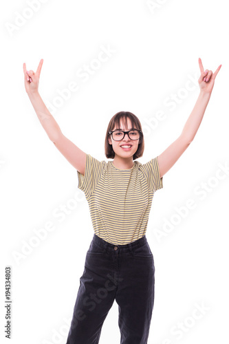 Fashion teen girl hipster giving the Rock and Roll sign . Pretty models smiling on white background