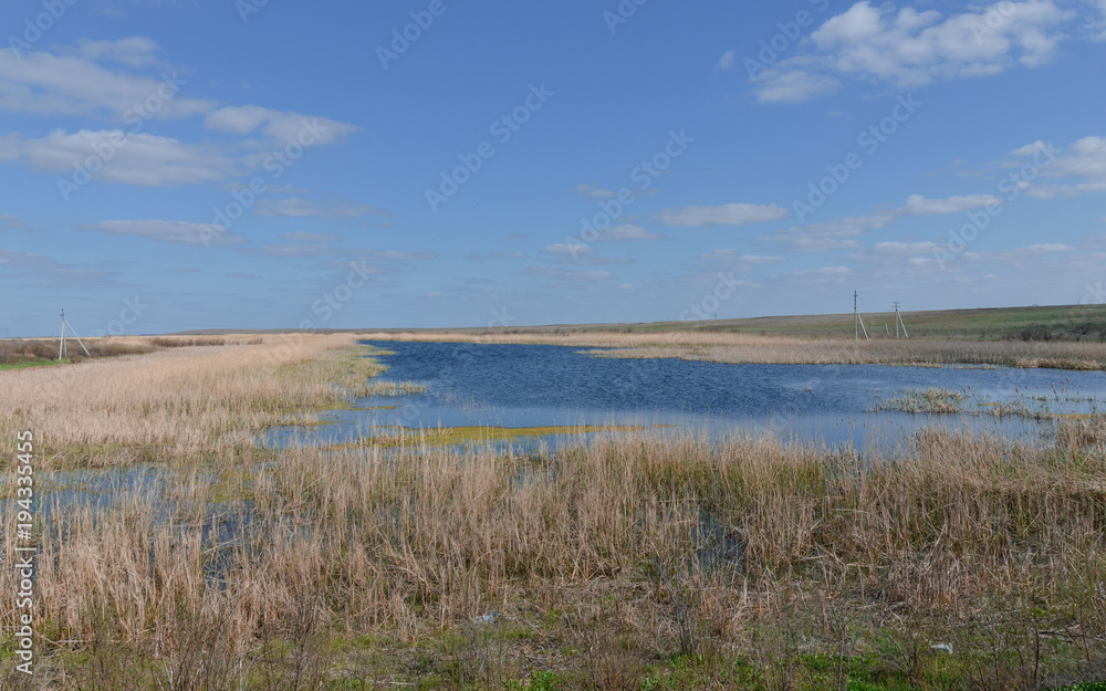 blue surface of yerik (shallow channel) Darma on sunny day in spring Astrakhan region, Russia