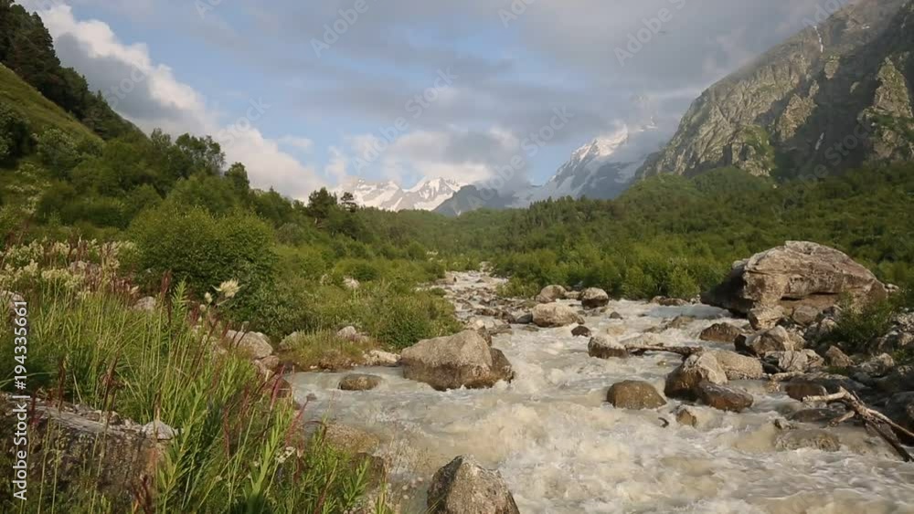 Russia. Movement of clouds and water flows in a stormy river in the Caucasus mountains in summer Russia. Movement of clouds and water flows in a stormy river in the Caucasus mountains in summer